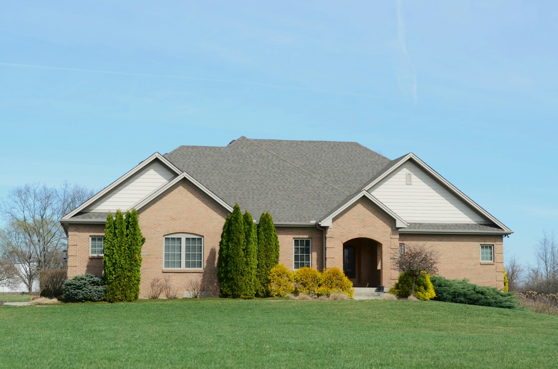 Brick home with a green front lawn